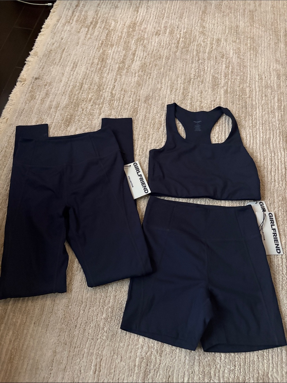 girlfriend collective navy sports bra with matching shorts and legging set